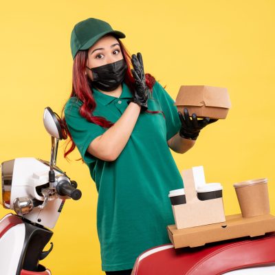 front-view-female-courier-mask-with-delivery-coffee-food-yellow-wall